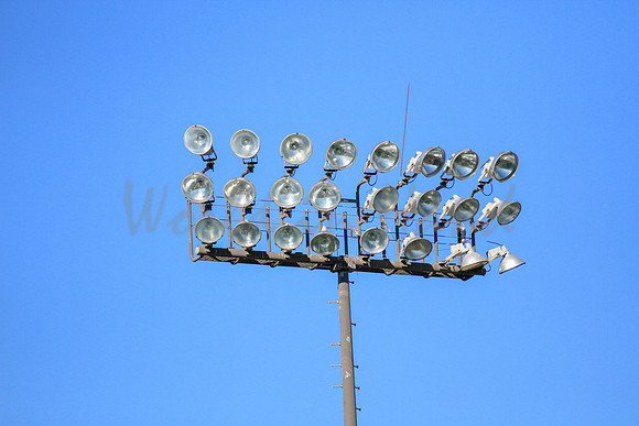 Stadium lights on a blue sky