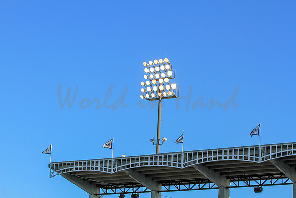Stadium lights on a blue sky