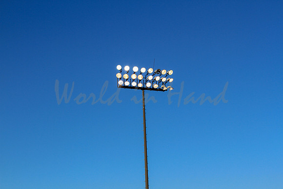 Stadium lights on a blue sky