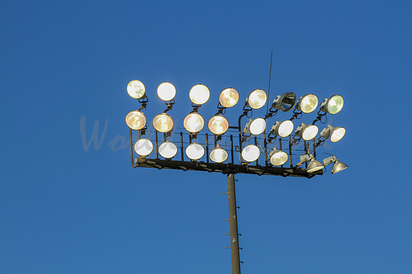 Stadium lights on a blue sky